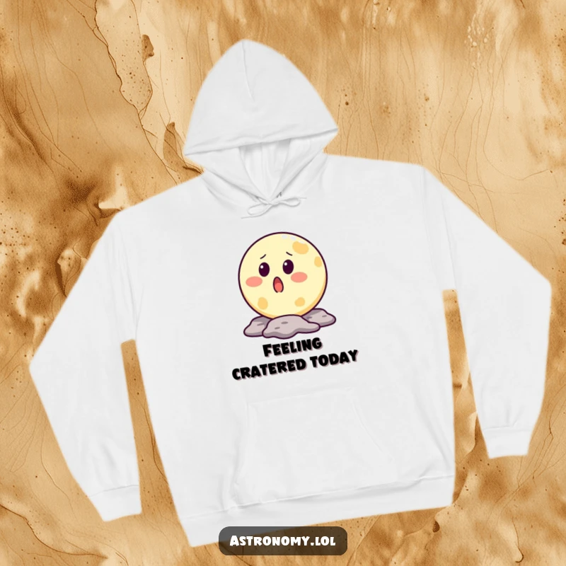 Funny moon hoodie featuring a surprised lunar character with a crater mouth, designed for warmth and humorous appeal.