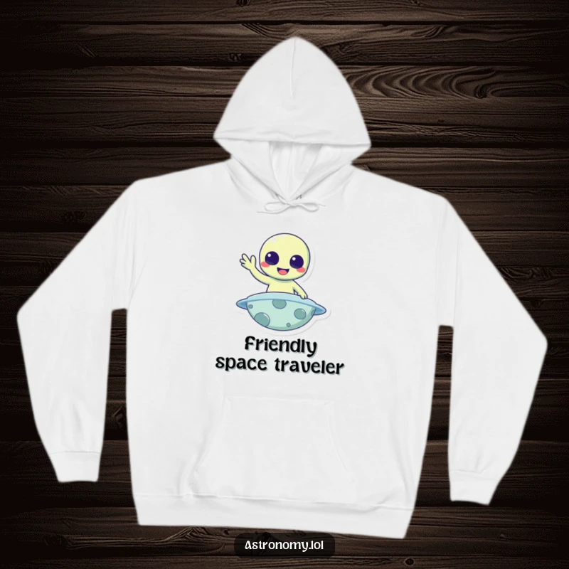 Funny Hoodie: A cheerful alien waves hello from a planet, radiating warmth and friendly vibes.