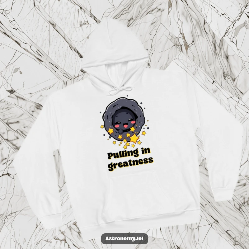 Funny hoodie featuring a delighted black hole character playfully absorbing small stars, designed for ultimate comfort and cosmic fun.