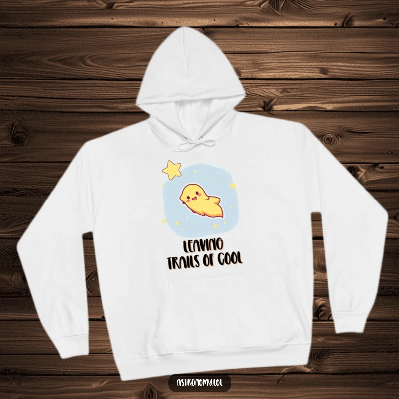 Funny hoodie showcasing a happy comet with a dynamic streaking tail against a starry backdrop, offering cozy humor.