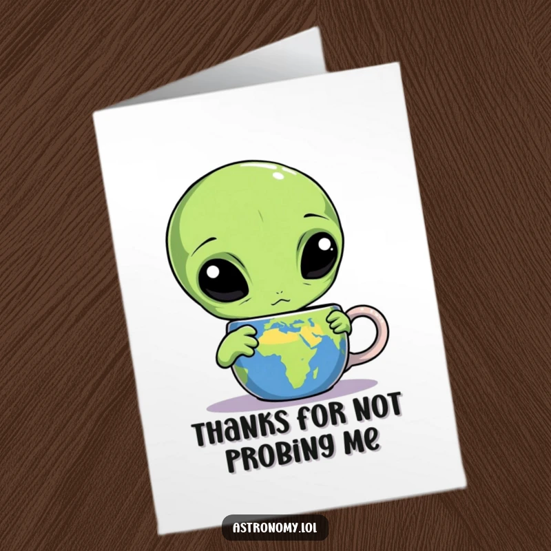 Funny Free Printable Thank You Card: Three-eyed alien looks confusedly at an Earth mug, thanking you.