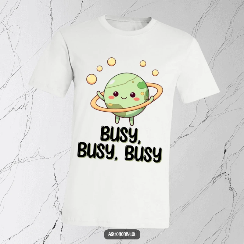 Funny happy planet t-shirt with a smiling face, skillfully juggling moons with its colorful rings, perfect for astronomy fans.