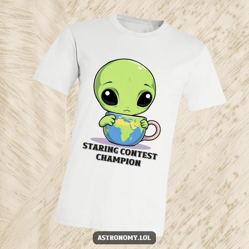 Funny alien t-shirt featuring a confused three-eyed extraterrestrial staring at an Earth-themed mug, a humorous depiction of cosmic interest.